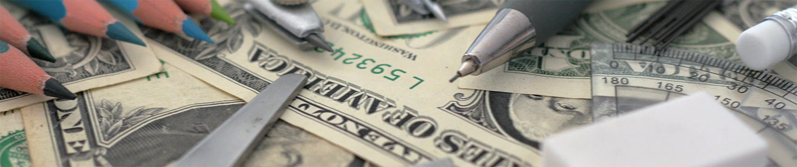 Pencils, scissors, eraser, and protractor laying on top of dollar bills