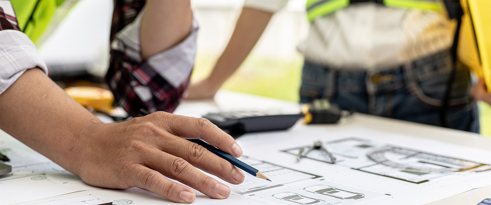 Workers' hands resting on floor plans