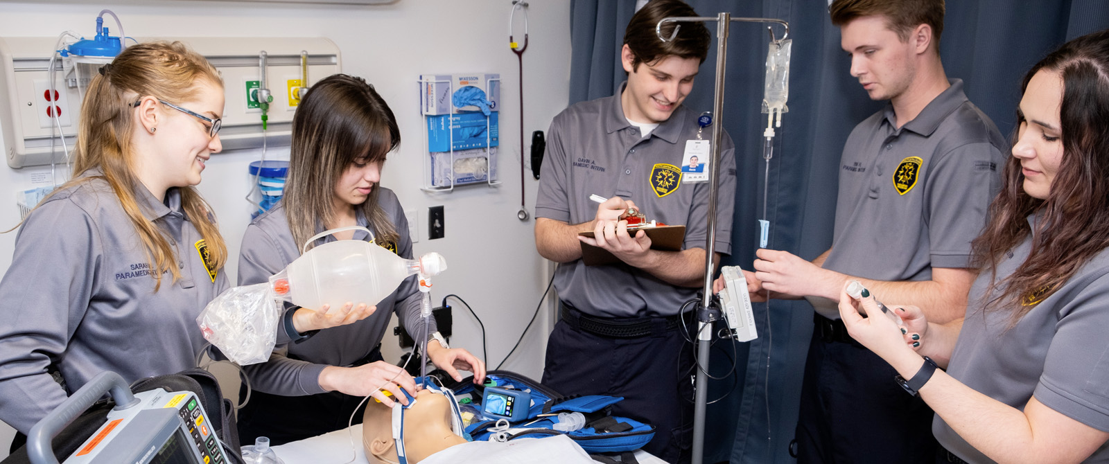 Students in a medical lab working with a patient simulator