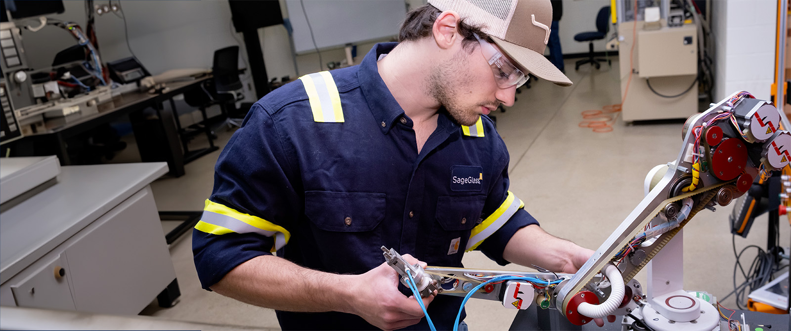 Student working on robotic arm in lab