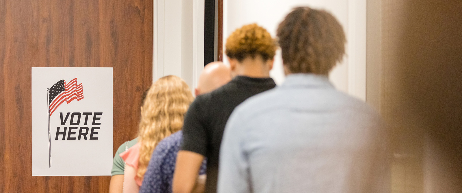 A group of voters standing in line to vote