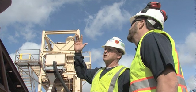 Miners working on job site pointing and talking about safety inspections