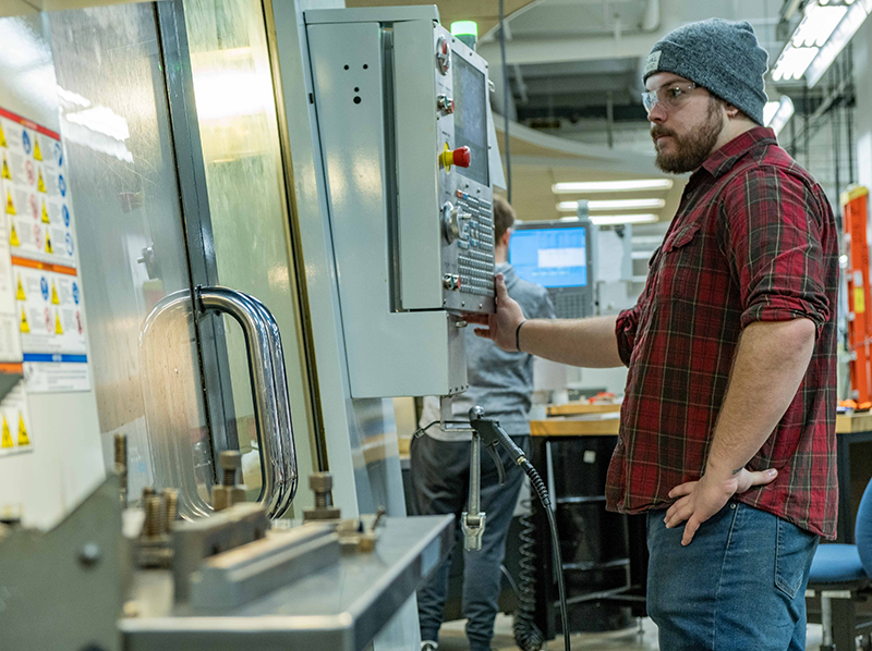 Student operating CNC equipment