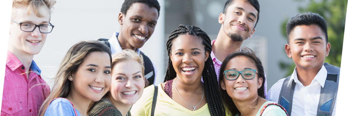 Photo of diverse group of high school students smiling at camera