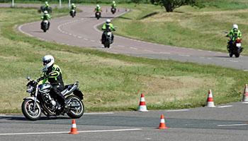 Group of motorcycles negotiating a turn on a closed training course