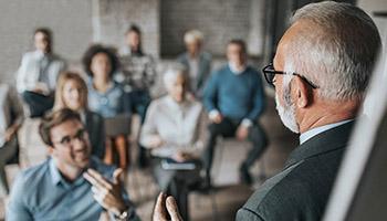 Instructor presenting to a room of professionals