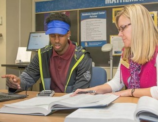 Photo of student and staff member in the advising center