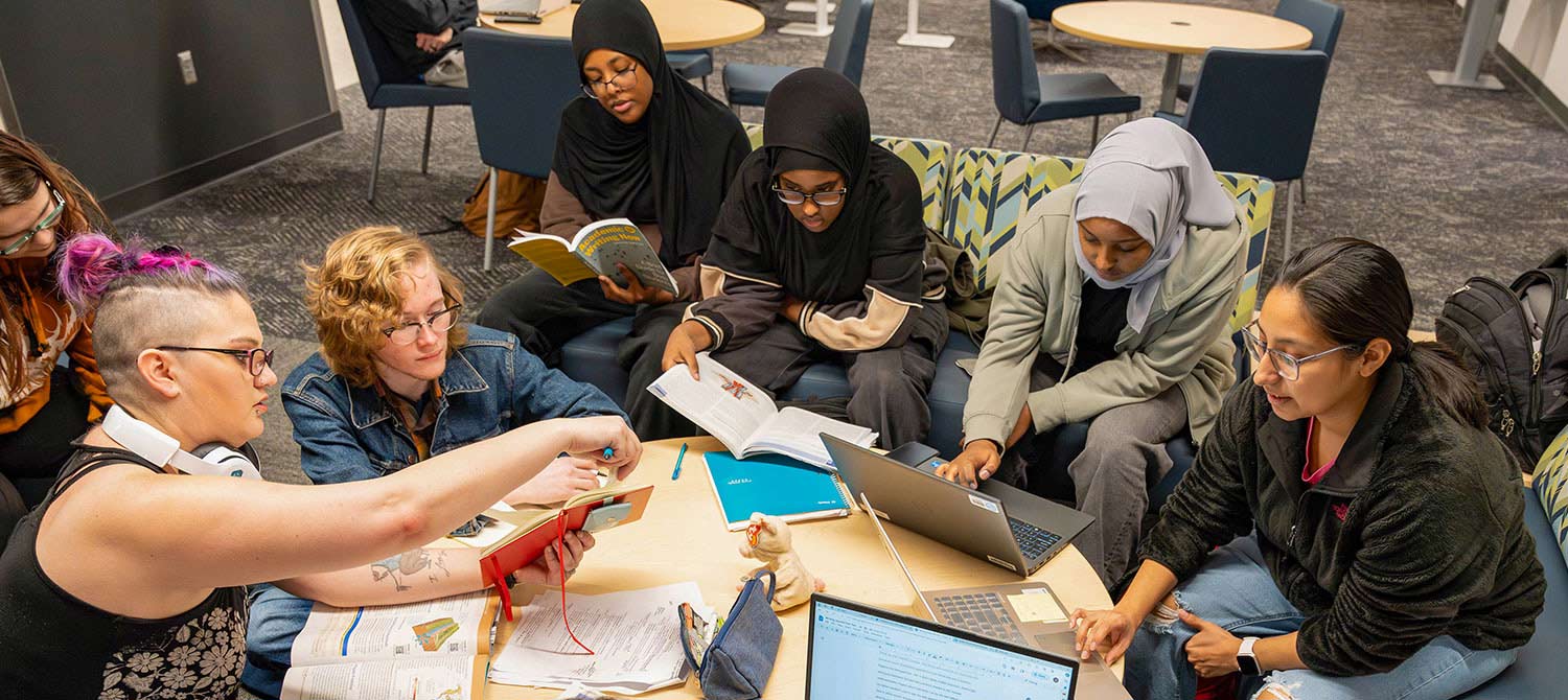 Group of students studying together in student lounge